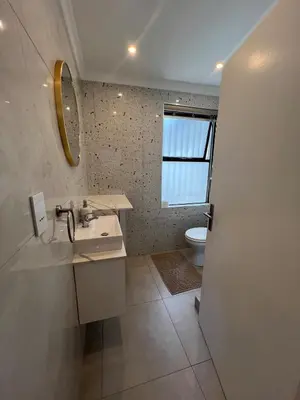a bathroom with a sink and a toilet at 4 sleeper Lamsyh Apartment in Cape Town