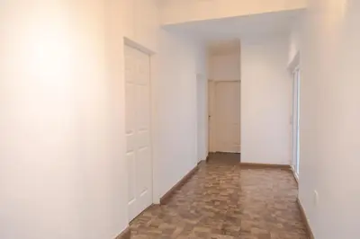 an empty hallway with white walls and tile floors at Vredekloof Views in Cape Town
