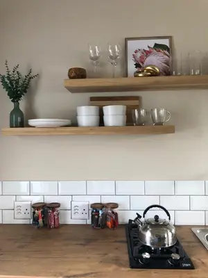a kitchen with a stove with a tea pot on it at Bettys Bay Breakaway in Bettyʼs Bay