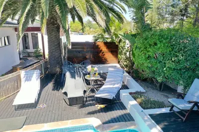 a patio with a table and chairs and a pool at 2stay Apartment Protea - Cape Town Bloubergstrand in Cape Town