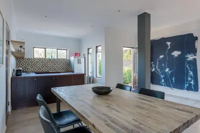 a dining room with a wooden table and chairs at 2stay Apartment Protea - Cape Town Bloubergstrand in Cape Town