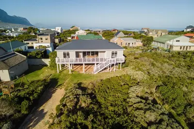 an aerial view of a house on a hill at Tides in Bettyʼs Bay