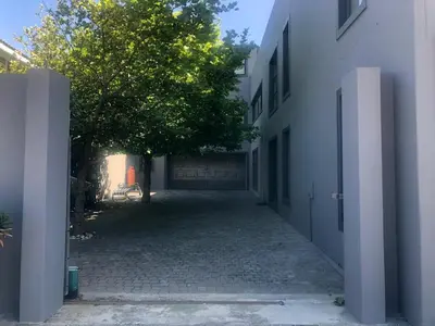 an empty alley with a tree and a building at 82 on Second family stay in Kleinmond