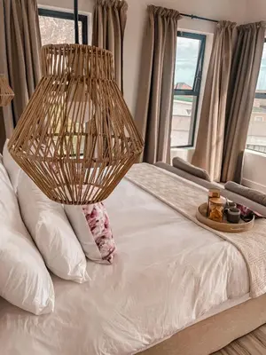 a bed with a plate of food on top of it at 155 Hangklip self catering in Pringle Bay