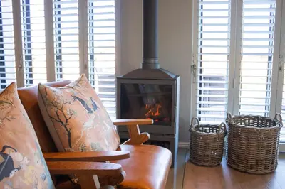a living room with a couch and a fireplace at MOS- Palmiet in Kleinmond