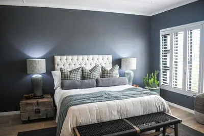 a bedroom with a large bed with blue walls at MOS-Palmiet 72 in Kleinmond