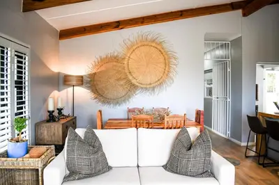 a living room with a white couch and a table at MOS-Palmiet 72 in Kleinmond