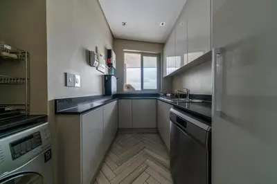 a small kitchen with a sink and a dishwasher at Apartment 206 Andringa Walk in Stellenbosch