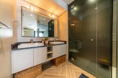 a bathroom with two sinks and a shower at Apartment 206 Andringa Walk in Stellenbosch