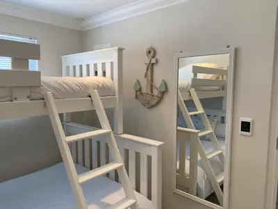 a bedroom with a bunk bed and a mirror at Bright apartment in Cape Town