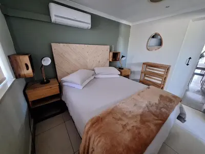 a bedroom with a large white bed and a window at KeMi Country House in Caledon