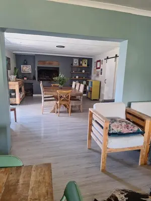 a living room with a table and a dining room at KeMi Country House in Caledon