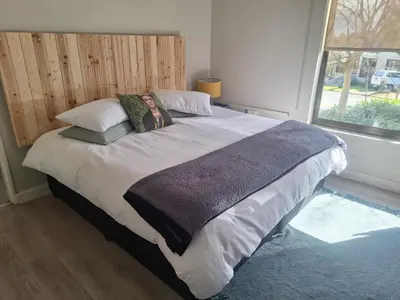 a bedroom with a large bed with pillows and a window at KeMi Country House in Caledon