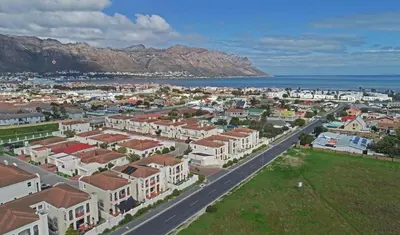 an aerial view of a city with houses and the ocean at Rehoboth in Cape Town