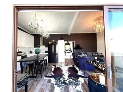 a kitchen and a living room with a table and a dining room at Dior Maison de Reve- Private Penthouse in Stellenbosch