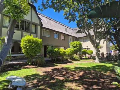 an exterior view of a building with trees at Afton Safari Lodge in Cape Town