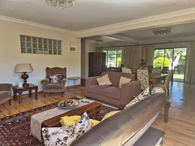 a living room with a couch and a table at Afton Safari Lodge in Cape Town