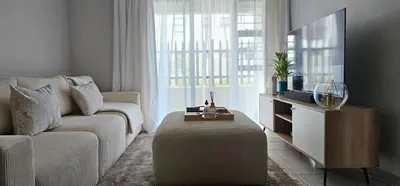 a living room with a couch and a tv at 33 Langeberg Heights in Cape Town