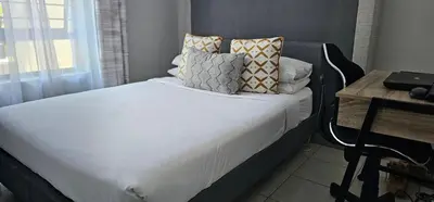 a bed with pillows on it in a bedroom at 33 Langeberg Heights in Cape Town