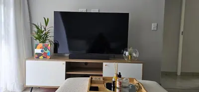 a flat screen tv sitting on top of a entertainment center at 33 Langeberg Heights in Cape Town