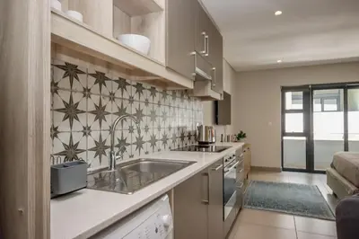 a kitchen with a sink and a counter top at 18 on The Den Studio Apartment in Stellenbosch