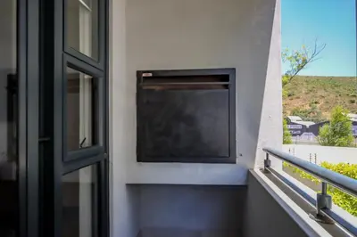 a television on the side of a building with a window at 18 on The Den Studio Apartment in Stellenbosch