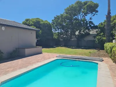 a swimming pool in the backyard of a house at Flamingle at Coot in Cape Town