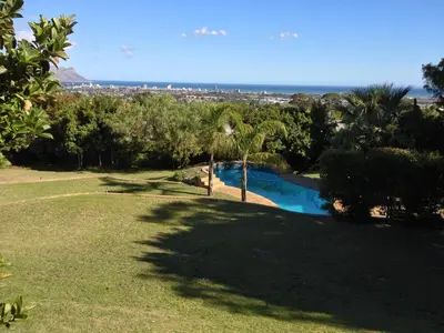 a view of a park with a swimming pool at Tolbos Grand in Somerset West