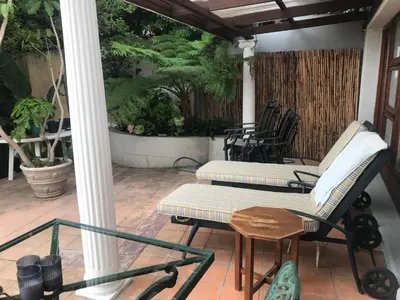 two chairs and a table on a porch at Tolbos Grand in Somerset West