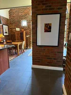 a brick wall with a picture hanging on it at Urban Oasis loft in Stellenbosch in Stellenbosch