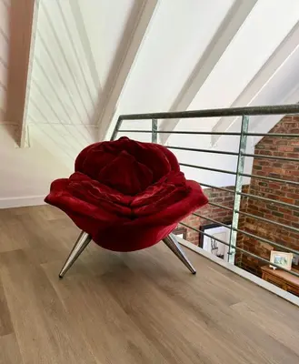 a red chair with a blanket on top of it at Urban Oasis loft in Stellenbosch in Stellenbosch