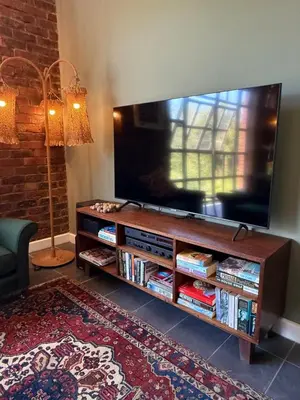 a living room with a flat screen tv on a entertainment center at Urban Oasis loft in Stellenbosch in Stellenbosch