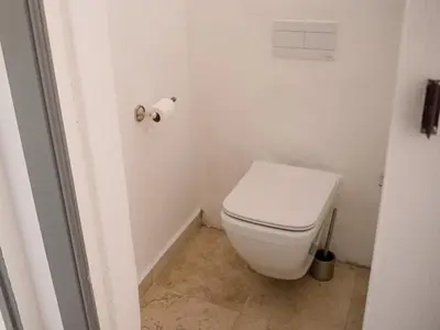 a bathroom with a toilet and a roll of toilet paper at Morgenzon Farm in Wellington