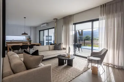 a living room with a couch and a table at Luxury Golf Villa 710, Pearl Valley Golf Estate in Simondium