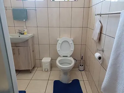 a small bathroom with a toilet and a sink at Oakway Guest Suite 2 Beds 1Bath Aircon Kitchen Private in Kuilsrivier