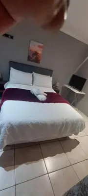 a bedroom with a bed with a pillow on it at The Resting Nest in Mandalay