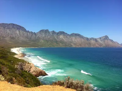 a view of a beach with mountains in the background at 