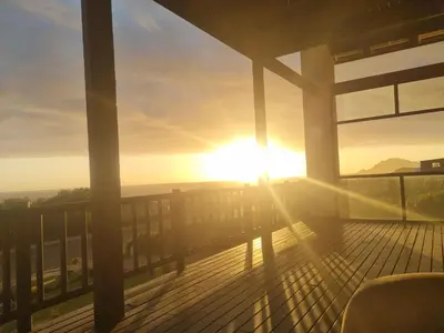 a view of the sun setting from a balcony at La Mer in Bettyʼs Bay
