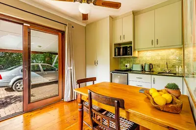 a kitchen with a wooden table with a bowl of fruit on it at 5 on Paul Kruger in Somerset West