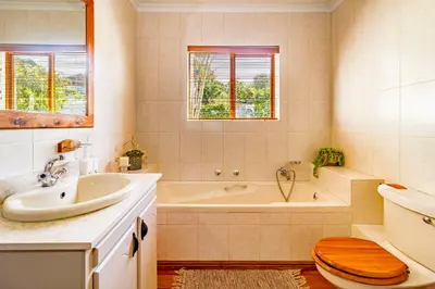 a bathroom with a tub and a sink and a toilet at 5 on Paul Kruger in Somerset West