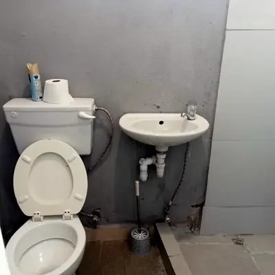 a bathroom with a toilet and a sink at Fairbridge Queens and Kings Guest House in Cape Town