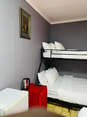 a room with two bunk beds and a red box at Fairbridge Queens and Kings Guest House in Cape Town