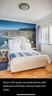 a bedroom with a bed and an entire bedroom with bath shower and toilet at Onrus Beach House in Hermanus