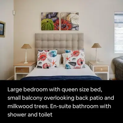 a large bed with a large bedroom with queen size bed and small bedroom overflowing back at Onrus Beach House in Hermanus