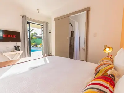 a bedroom with a bed with a view of a pool at Cape Town 4U Guesthouse in Cape Town