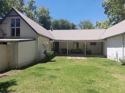 a small white house with a large yard at Greystone in Greyton