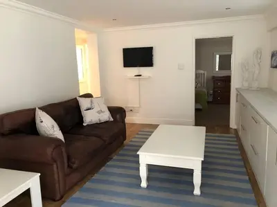a living room with a couch and a coffee table at Onrus Home with a Sea View in Hermanus
