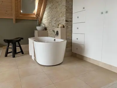 a white bath tub in a kitchen with a stool at Soul Place in Pringle Bay