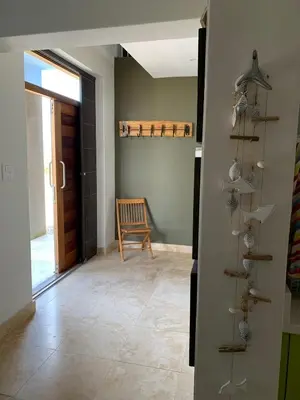 a hallway with a room with a door and a chair at Soul Place in Pringle Bay