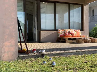 a porch with a couch and a bench on a house at Soul Place in Pringle Bay